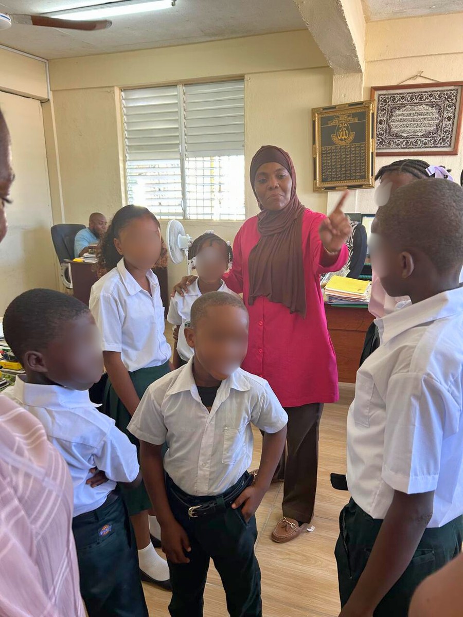 Nicole Johnson meeting with school staff at Muslim Community Primary School in Belize City